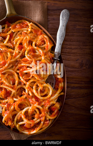 Pasta mit Guanciale, Zwiebeln, Tomaten, rote Chili-Flocken und Pecorino-Käse. Stockfoto