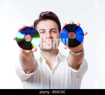 Mann im Hemd stehen lächelnd halten CDs - isoliert auf weiss Stockfoto