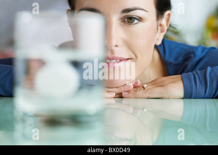 Frau betrachten Brausetablette in Wasser auflösen Stockfoto