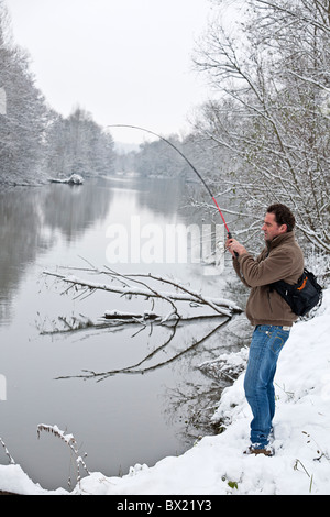 Im Winter, ein Angler am Ufer des Flusses Allier (Frankreich). Pêcheur à la Ligne Sur Une des Berges de l' Allier, En Hiver. Stockfoto