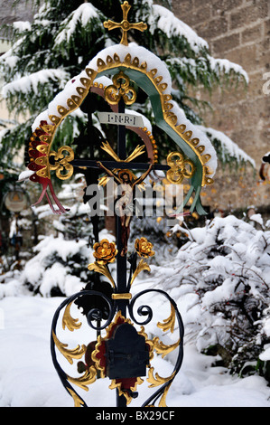 Schneebedeckte Grabmarkierung im Petersfriedhof oder Petersfriedhof, Salzburg, Österreich Stockfoto