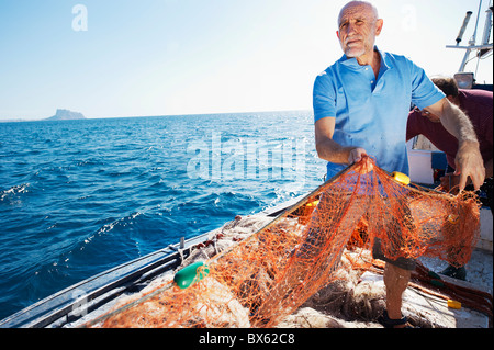 Fischer am Boot ziehen in Netzen Stockfoto