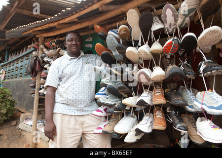 Ein Ladenbesitzer steht neben Schuhe zum Verkauf in Kakata, Liberia, Westafrika. Stockfoto