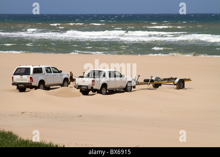 Fahrzeuge am Strand mit Bootsanhänger am Cape Vidal, iSimangaliso Wetland Park, Kwazulu Natal, Südafrika Stockfoto