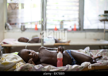 Ein Junge Cholera-Patienten liegt auf einem Feldbett in das Hospital Albert Schweitzer auf Donnerstag, 28. Oktober 2010 in Deschapelles, Haiti. Stockfoto