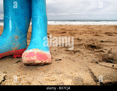 Paar von farbigen Wellington Stiefel am Strand Stockfoto