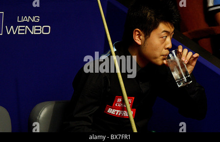 Liang Wenbo von China im Kampf gegen Ronnie OSullivan von England, während der 1. Runde der Snooker-Weltmeister Betfred Stockfoto