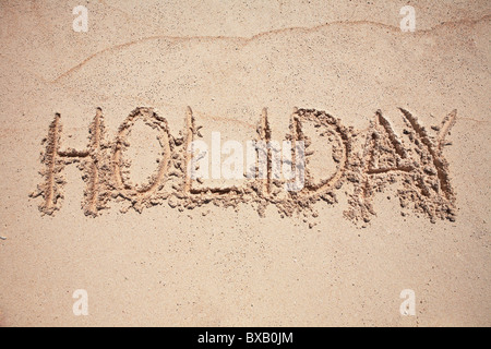 Urlaub auf Sand geschrieben Text Stockfoto