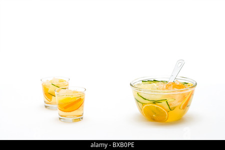 Früchtepunsch in Schüssel geben und in Gläsern Stockfoto