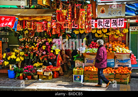 Orientalische Frau zu Fuß vor Obst und Gemüse Markt in der Innenstadt von Hongkong China Stockfoto
