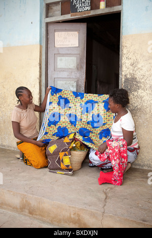 Eine junge Frau verkauft Stoffe und Textilien Tür zu Tür in Dodoma, Tansania, Ostafrika. Stockfoto