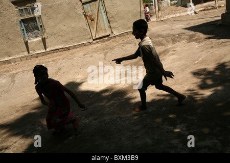 Kinder spielen in der Zigeuner Dorf von Gigikhana in der Nähe von Buchara, Usbekistan. Stockfoto
