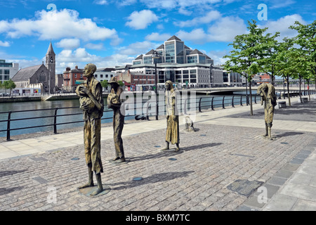 Das Famine Memorial am Custom House Quay auf den Fluss Liffey in Dublin Irland mit One Georges Quay Plaza über den Fluss. Stockfoto