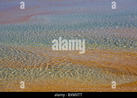 Abstrakte Nahaufnahme von Agua farbige flache Wasserlachen am Strand am Rande des Atlantischen Ozeans Stockfoto