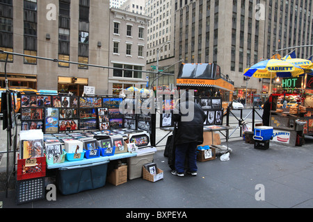 Ein Taxi-Tours-Bus Kreuzfahrten von einem Händler Verkauf Tourist Fotos auf der Sixth Avenue von New York City in Weihnachten 2010 Stockfoto