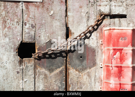 Metall-Kette Sperren einer alten Holztür Stockfoto