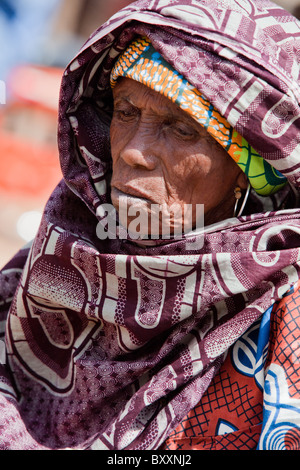 In der Stadt Djibo im nördlichen Burkina Faso hält ein älterer Fulbe-Frau auf dem Markt, Grüns für das Abendessen zu kaufen. Stockfoto