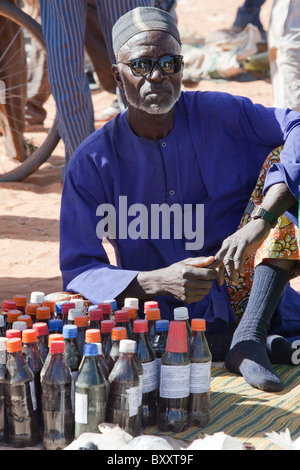 Auf dem Wochenmarkt in Djibo, nördlichen Burkina Faso, eine Menschenmenge versammelt um einen Schlangenbeschwörer / traditionellen Medizinmann. Stockfoto