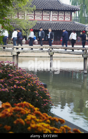 Menschen Kreuzung Fußgängerbrücke in Humble Administrator Garten (UNESCO Weltkulturerbe), Suzhou, Jiangsu, China Stockfoto