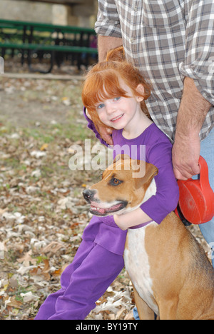 Ein kleines Mädchen mit ihrem Hund in einem Park. Zeigt die Freundschaft zwischen Kindern und des Tieres Stockfoto