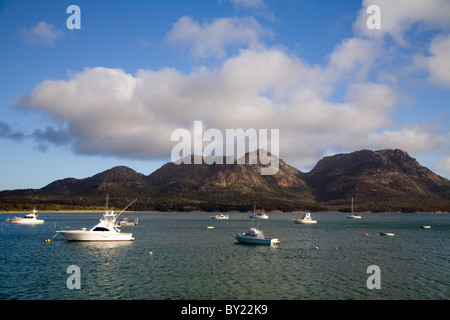 Australien, Tasmanien, Freycinet National Park, Coles Bay.  Boote in Coles Bay, mit den Gefahren Bergkette jenseits. Stockfoto