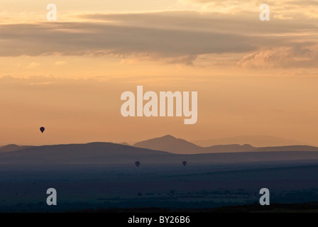 Tagesanbruch über Masai-Mara als Heißluft Ballons Drift über die Ebenen. Stockfoto