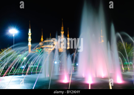 ISTANBUL, Türkei / Türkiye - beleuchteter Brunnen im Sultanahment Park mit der Blauen Moschee im Hintergrund. Sultan-Ahmed-Moschee (türkisch Sultanahmet Camii), im Volksmund als Blaue Moschee bekannt, ist eine muslimische (sunnitische) Moschee im Zentrum von Istanbuls Altstadt von Sultanahmet. Es wurde von Sultan Ahmed I. in Auftrag gegeben und 1616 fertiggestellt. Stockfoto