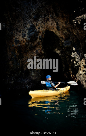 Eine Frau Paddel ihr Kajak in einer Meereshöhle auf Santa Cruz Island auf den Kanalinseln aus Santa Barbara, CA. Stockfoto
