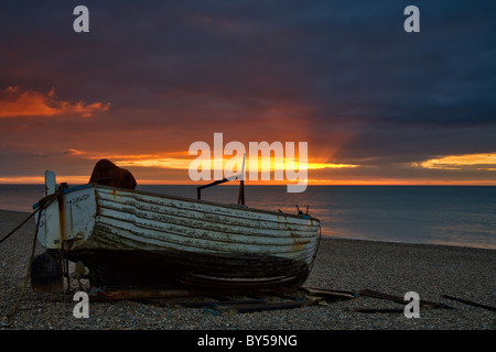 Sunrise Beach Dunwich und traditionellen Suffolk Fischerboot am Ufer Stockfoto