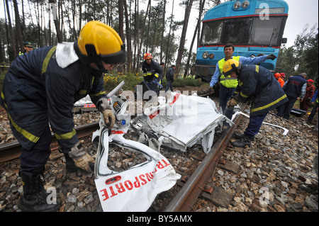 Feuerwehr sammeln die Reste eines Autos durch die Kollision mit einem Zug zerstört Stockfoto