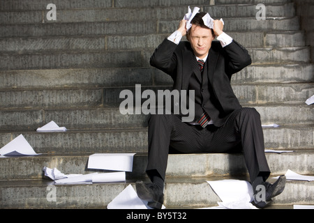 Bild von frustrierten Professional mit seinen Augen geschlossen in Trauer während der Krise Stockfoto