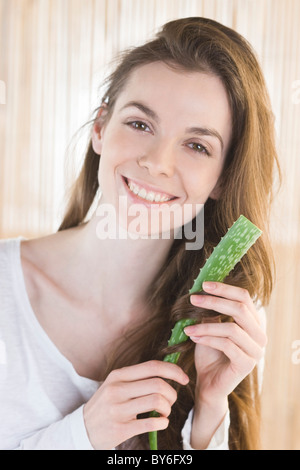 Junge Frau mit Aloe Vera Blatt Stockfoto