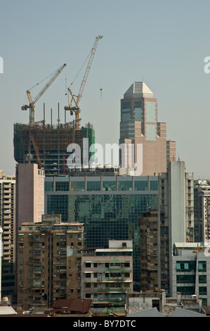 Bauarbeiten auf der chinesischen Insel Macau statt.   Moderne Neubauten steigen hinter älteren heruntergekommen sind. Stockfoto