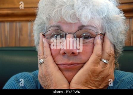 Senior Woman with her hands on her face. Stockfoto