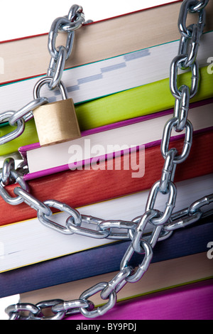 Stapel von bunte Bücher, geschützt mit einer Kette (auf einem weißen Hintergrund) Stockfoto