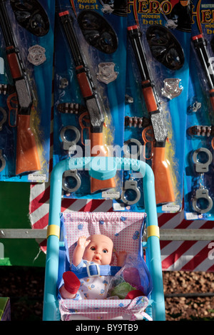 Puppe im Kinderwagen und Spielzeug Gewehre zum Verkauf an einen Spielzeug-stand auf der Fiesta San Sebastian in Adeje, Teneriffa, Kanarische Inseln, Spanien Stockfoto