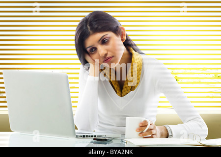 Geschäftsfrau, die Langeweile im Büro Stockfoto