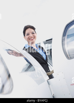 Geschäftsfrau auf corporate jet Stockfoto