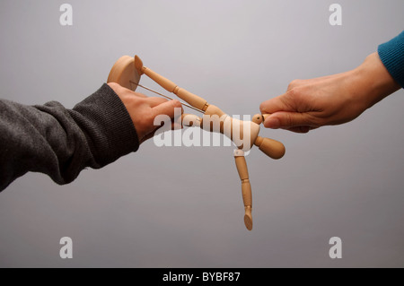 Eine Schaufensterpuppe in zwei Richtungen gezogen Stockfoto