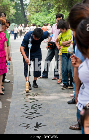 Chinesischer Mann üben Straße Kalligraphie auf dem Gelände des neuen Sommerpalast, Peking, China. JMH4796 Stockfoto