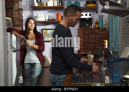 Paar in der Küche, Mann abwaschen Stockfoto