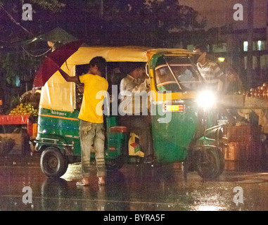 Indien, Agra, Uttar Pradesh Boys von Rikscha in Monsun-Regen Stockfoto