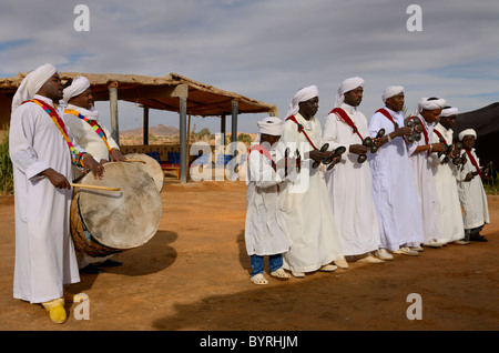 Gruppe von Gnawa-Musiker in weißen Gewändern, tanzen und spielen Krakeb und Trommel in Khemliya Dorf Marokko Nordafrika Stockfoto