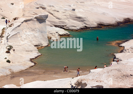 Menschen in Sarakiniko Strand, berühmt für seine blendenden weißen vulkanischen Felsen schwimmen. Insel Milos, Kykladen, Griechenland Stockfoto