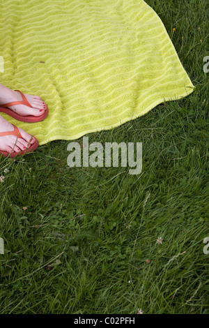 Füsse in Flip-flops auf einer Wiese Stockfoto