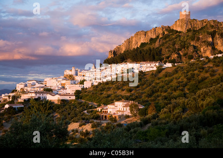 Entfernten typischen / traditionelle spanische weiße Dorf Zahara mit seinen Gebäuden & Wachturm in der Dämmerung / Sonnenuntergang / so festgelegt. Spanien Stockfoto