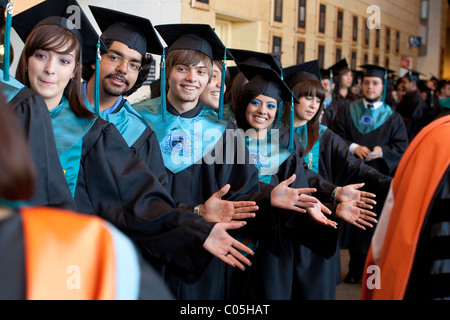High-School-jungen und Mädchen in Kappen und Kleider in der Schlange vor dem Einmarsch in Abschlussfeier Stockfoto