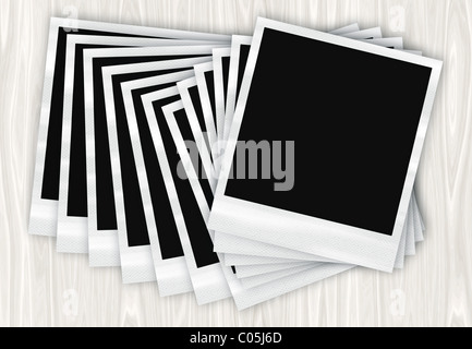 Ein Haufen von instant Film Fotos in einer Reihe auf einem Holztisch angeordnet. Stockfoto
