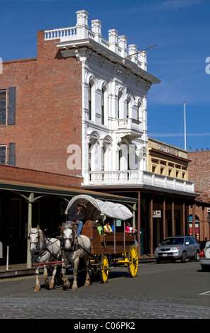 Touristen fahren in einem Pferd gezogenen Planwagen an Old Sacramento State Historic Park in Sacramento, Kalifornien, USA. Stockfoto