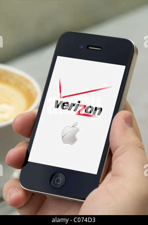 Mann Händchenhalten ein Iphone 4 zeigt Verizon Iphone in den USA erhältlich Stockfoto
